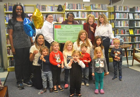 Leprino representatives, along with Kings County Library officials, accept a $20,000 check from Leprino Foods. Also on hand were several children visiting the Lemoore Library.The funds will be used to update technology for the Lemoore library.